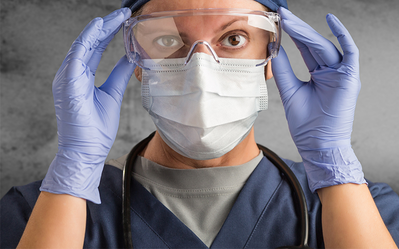 female nurse fixing her glasses